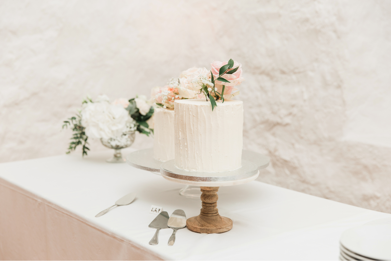 Mesa con tarta de boda y flores suaves